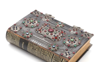 A hymnal with silver mountings and clasps with numerous coloured glass stones. 19th century. H. 19.5. L. 13 cm.
