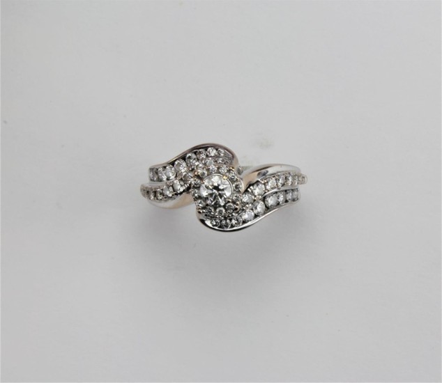 A ladies single stone dress ring, with floral diamond should...