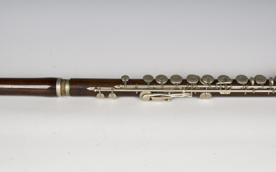 A late 19th century rosewood flute with nickel keywork, cased (thin hairline crack to one section).