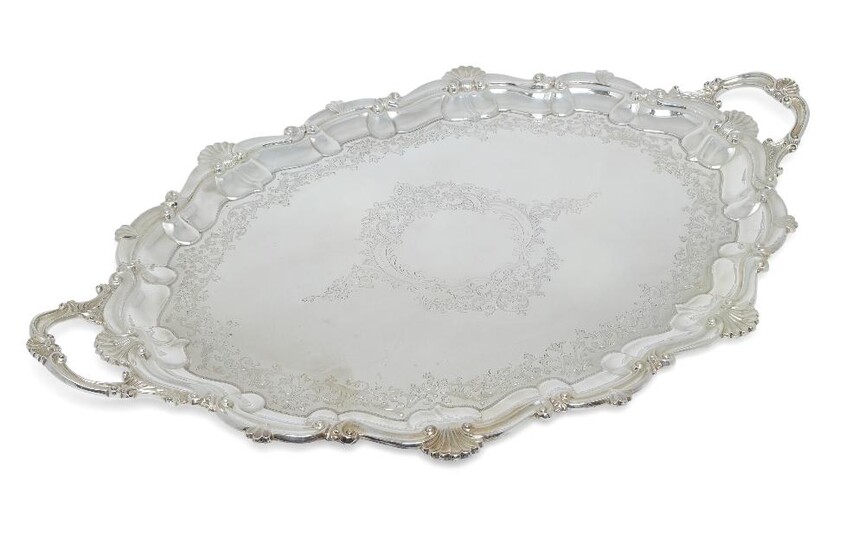 A late Victorian twin-handled silver tray, Sheffield, 1900, Atkin Bros, retailed by JW Benson, of shaped oval form, designed with shell and scroll border to foliate scroll engraved base, 73.5cm long (inc. handles), approx. weight 120oz