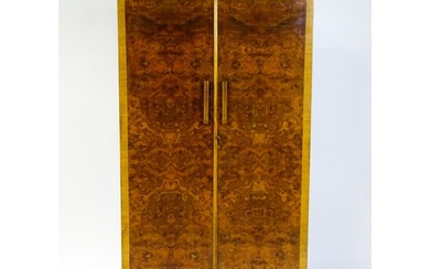 A mid 20thC Art Deco style wardrobe / cupboard with burr wal...