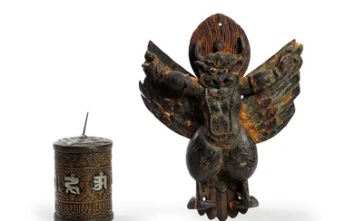 A painted wood figure of Garuda and a copper alloy repoussé prayer...