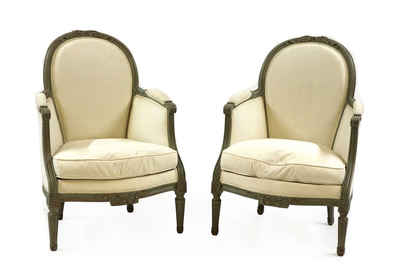 A pair of French Louis XVI style painted bergeres