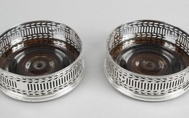 A pair of George III silver mounted wine coasters, each