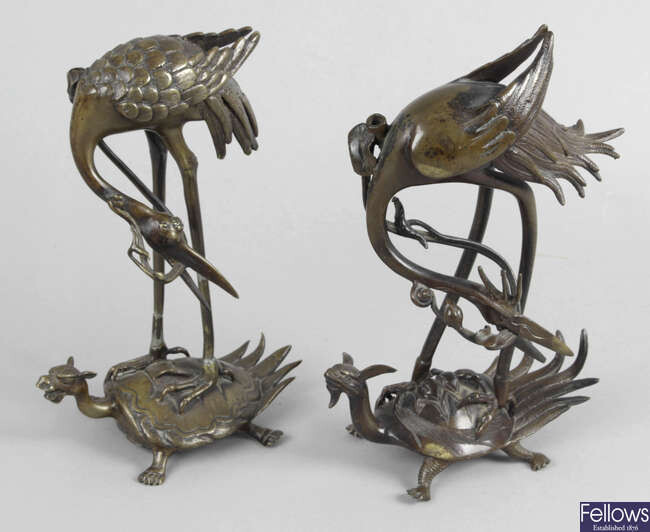 A pair of Oriental bronze animalier figures.