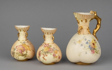 A pair of Royal Worcester vases, the blush ivory ground decorated with flowers and gilt below crabstock handles, tallest: 6 1/2 in. (16.5 cm.) h.