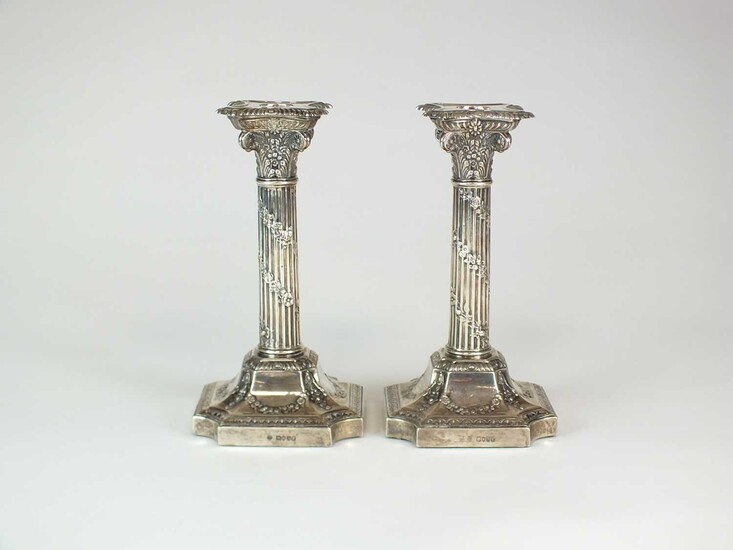 A pair of Victorian silver Corinthian column candlesticks