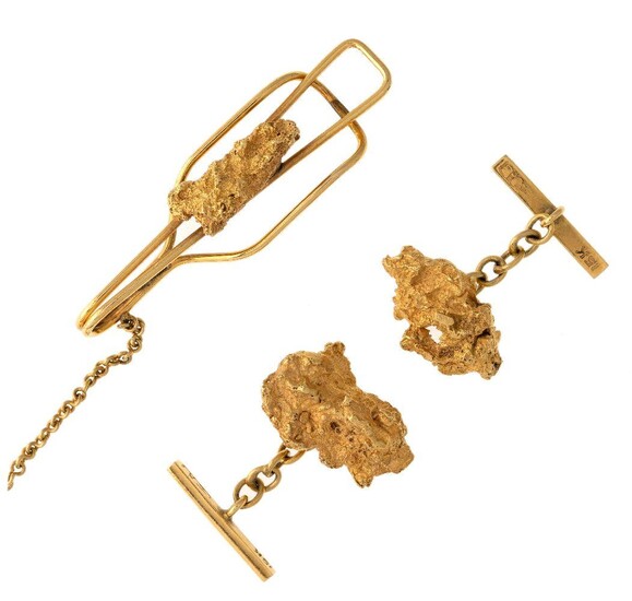 A pair of cufflinks and a tie slide, the cufflinks each composed of a nugget to baton back bar with curb link chain connections, the ties slide of matching design