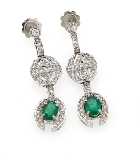 NOT SOLD. A pair of emerald and diamond ear pendants each set with an oval-cut...