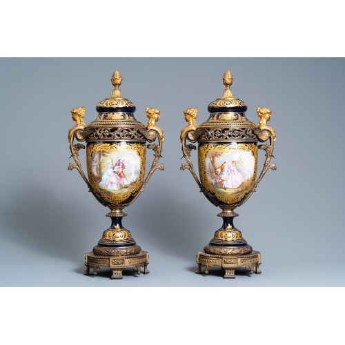 A pair of large French Sèvres-style vases with gilded bronze...