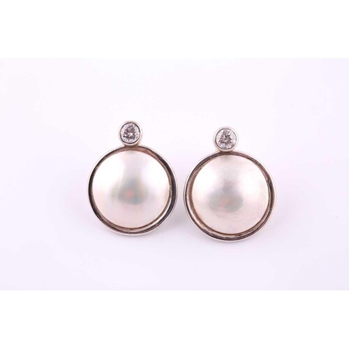 A pair of mabe pearl and diamond earrings Each collet-set br...