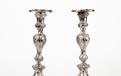 A pair of rococo style nickel silver candlesticks, later part of the 19th century.