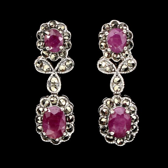 A pair of ruby and marcasite ear pendants each set with two oval-cut rubies and numerous circular-cut marcasites, mounted in rhodium plated sterling silver.