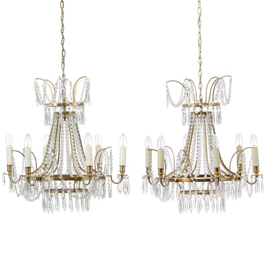 A pair of small Swedish six-light chandeliers with brass frames. Electrical. Empire style, late 20th century. H. (ex. chain) 65 cm. Diam. 57 cm. (2).