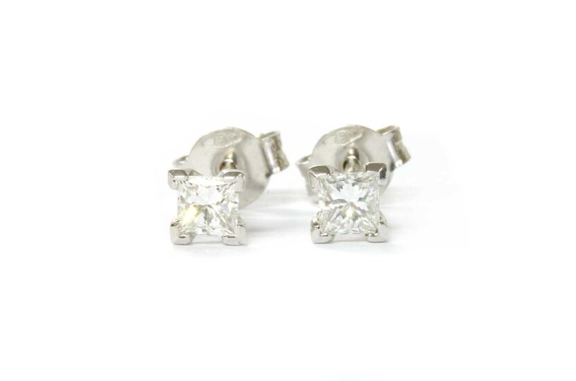 A pair of white gold princess cut diamond stud earrings