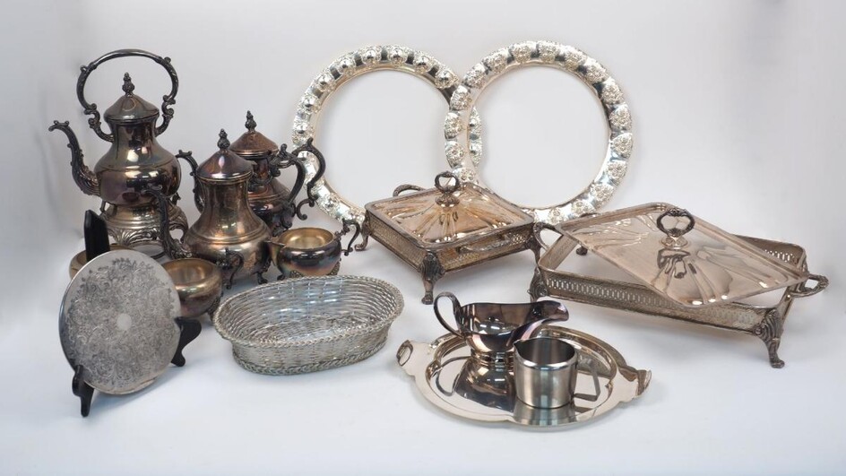 A quantity of silver plate, including: various pierced twin-handled mounts for serving dishes (with covers, liners deficient); a shaped quatrefoil tray; a set of place mats, a tea service and a butter dish (a lot)