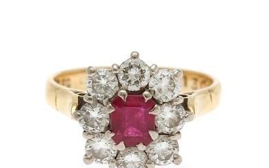 A ruby and diamond ring set with an emerald-cut ruby encircled by eight brilliant-cut diamonds, mounted in 18k gold and platinum. Size 54.