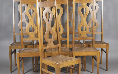 A set of eight Arts and Crafts oak framed chairs, after a design by Charles Francis Annesley Voysey