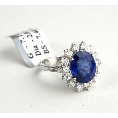 AN 18CT WHITE GOLD, 7.4CT OVAL CUT SAPPHIRE AND 2.01CT ROUND...
