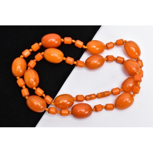AN AMBER COLOURED BAKELITE BEAD NECKLACE, designed with thir...