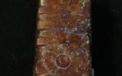 AN ANTIQUE JADE PENDANT CARVED WITH PATTERN