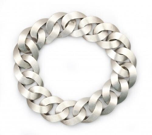 An 18 carat white gold twisted link bracelet. Composed of a series of brushed flat shaped links to an invisible clasp. Gross weight: 76.4 g.