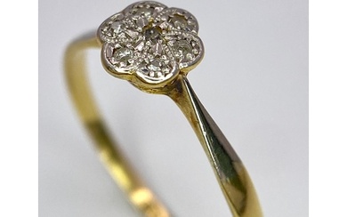 An 18K Yellow Gold, Platinum Diamond Ring. Size Q. Seven old...