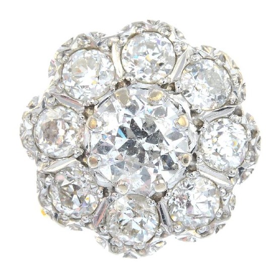An 18ct gold diamond cluster ring. The old-cut diamond
