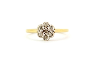 An 18ct yellow and white gold diamond set cluster ring, (P).