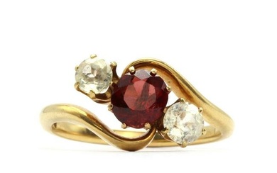 An Edwardian three stone garnet and white sapphire crossover ring