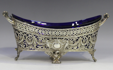 An early 20th century German silver two-handled boat shaped centrepiece basket, the sides decorated