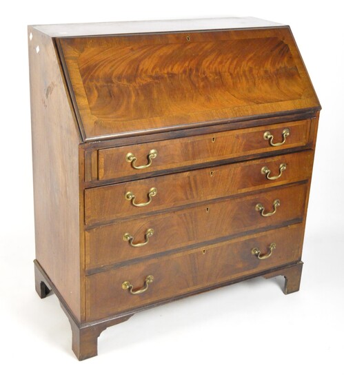 An early 20th century mahogany bureau, the drop front opening to reveal fitted interior