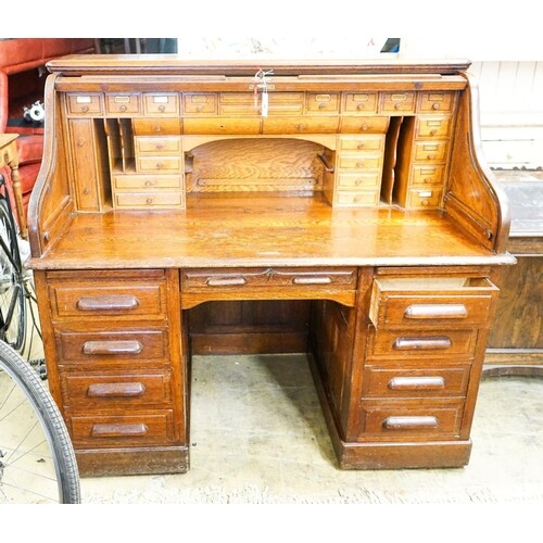 An early 20th century oak roll top desk with 'S' shape tambo...