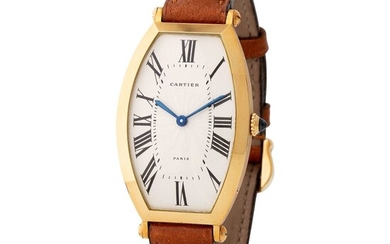 Cartier Paris. Rare and Graceful Tonneau-Shape Wristwatch in Yellow Gold, Reference 2435, With Silver Guillochè Roman Numbers Dial