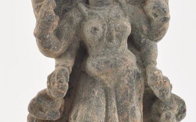 Early Indian carved grey stone standing buddha figure. Figure 13.5in high. Overall: 14.75in high.