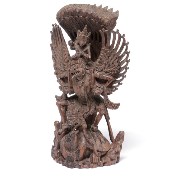 Figure of wood in the shape of Garuda and other mythical figures. Bali. H. 47 cm.