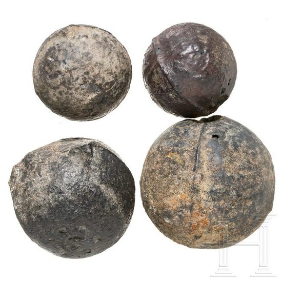 Four German cast iron cannon balls, 16th century