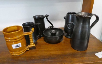 Group of black glazed ceramics with mustard coloured tankardGroup of...