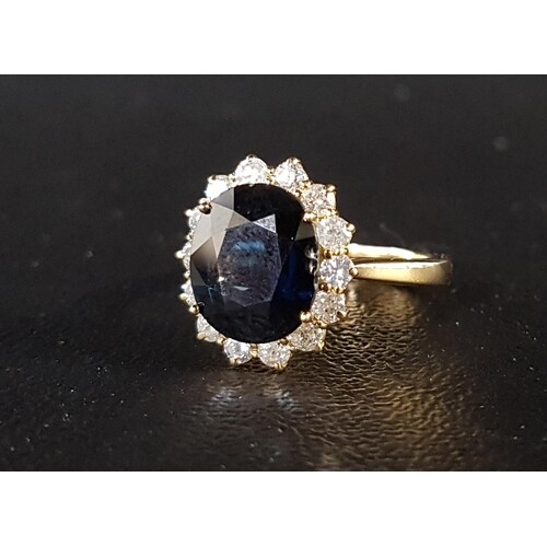 IMPRESSIVE SAPPHIRE AND DIAMOND CLUSTER DRESS RING the centr...