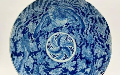 JAPANESE BLUE AND WHITE PORCELAIN CHARGER WITH DECORATION OF MYTHICAL BIRD AND DRAGON AMIDST CLOUD