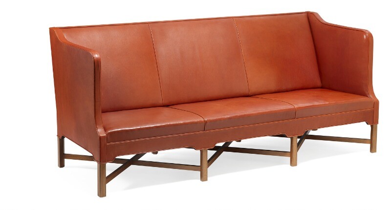 Kaare Klint: Freestanding three seater sofa on eight-legged, profiled mahogany cross-frame. Sides, seat and back upholstered with patinated red leather.