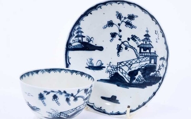 Lowestoft tea bowl and saucer, painted in blue with Chinese river landscapes and a berry border, saucer 12.2cm diameter