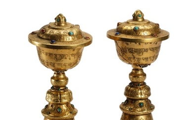 MATCHED PAIR OF TIBETAN INLAID BRONZE-GILT LARGE REPOUSSE BUTTER LAMPS