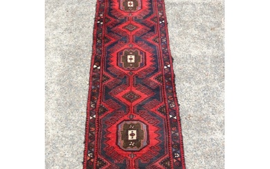 Old handwoven hall runner of red ground, approx 296 x 71cm