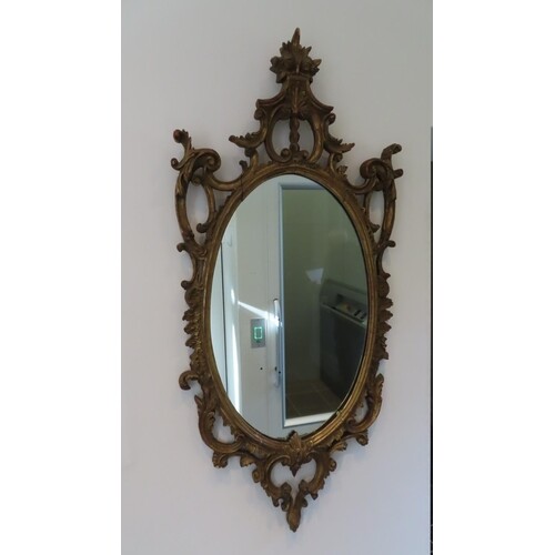 Oval carved gilt wood mirror in 18thC style with replacement...
