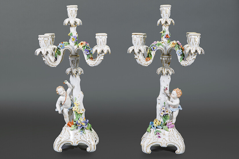 Pair of 5-light candlesticks convertible into Dresden enamelled porcelain candlesticks. Early 20th century. Children on the shaft in a round bulge, decoration with applied flowers and details in gold. With markings. Height: 51 cm. Exit: 600ur