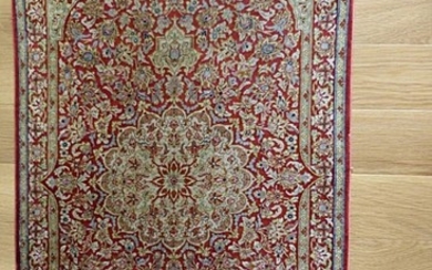 Qum silk rug, Persia. Classical medallion design on an red field. 20th century. 80×56 cm.