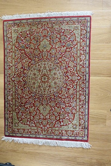 Qum silk rug, Persia. Classical medallion design on an red field. 20th century. 80×56 cm.