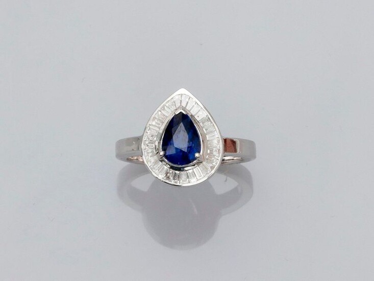 Ring featuring a pear-shaped platter in white gold, 750 MM, centered on a pear-cut sapphire weighing 1.97 carat in a row of baguette-cut diamonds, size: 54, weight: 5.75gr. rough.