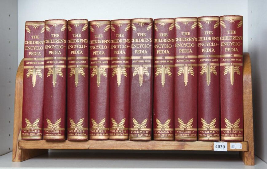 TEN VOLUMES OF THE CHILDREN'S ENCYCLOPEDIA IN A HARDWOOD BOOK STAND